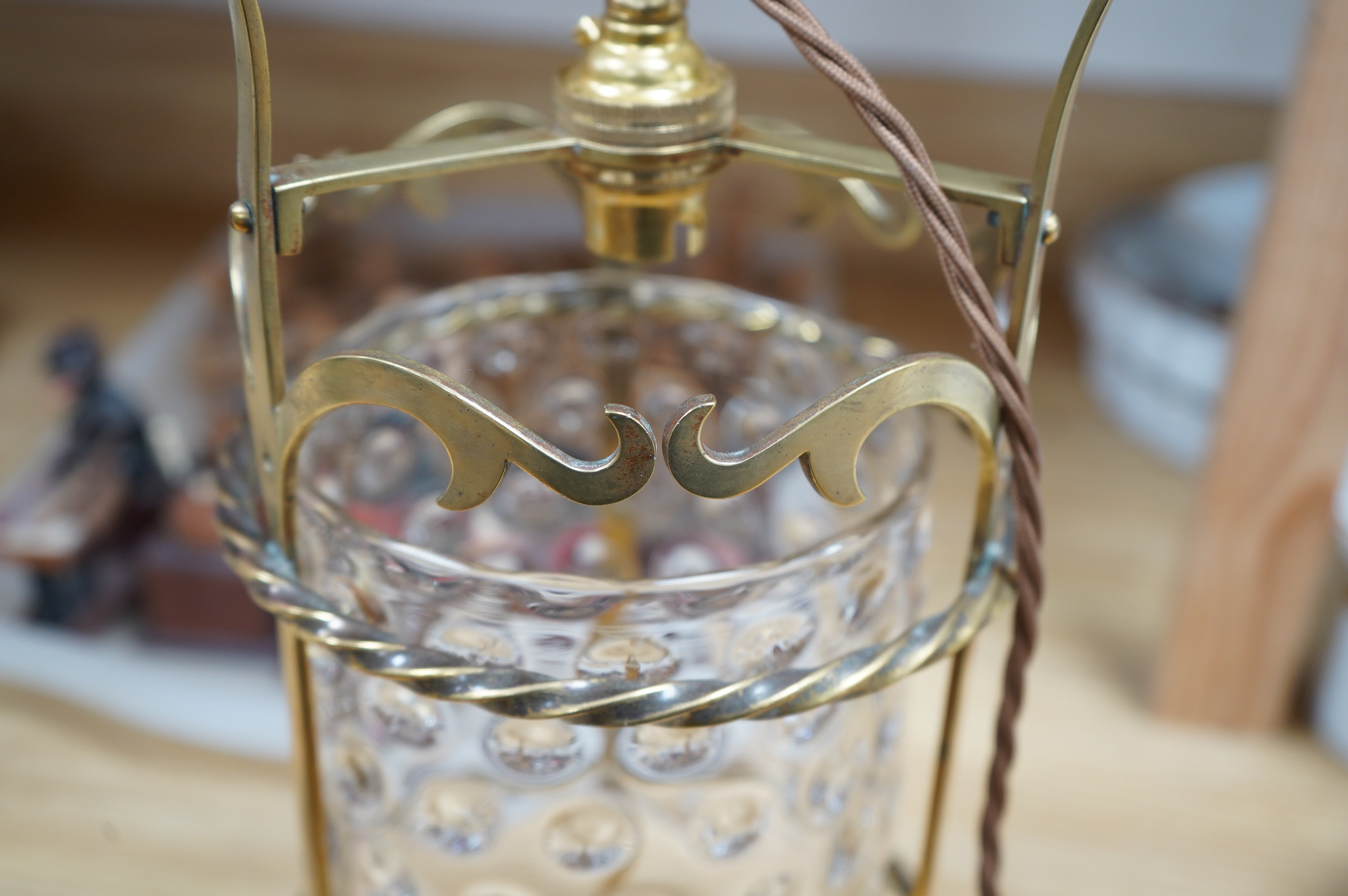 An English Art Nouveau brass lantern with wavy bubbly glass cylinder, c.1910-1920's, including chain and ceiling rose, wired, lantern 34cm high, diameter 13.5cm, glass 16.5cm high. Condition - glass shade a little loose